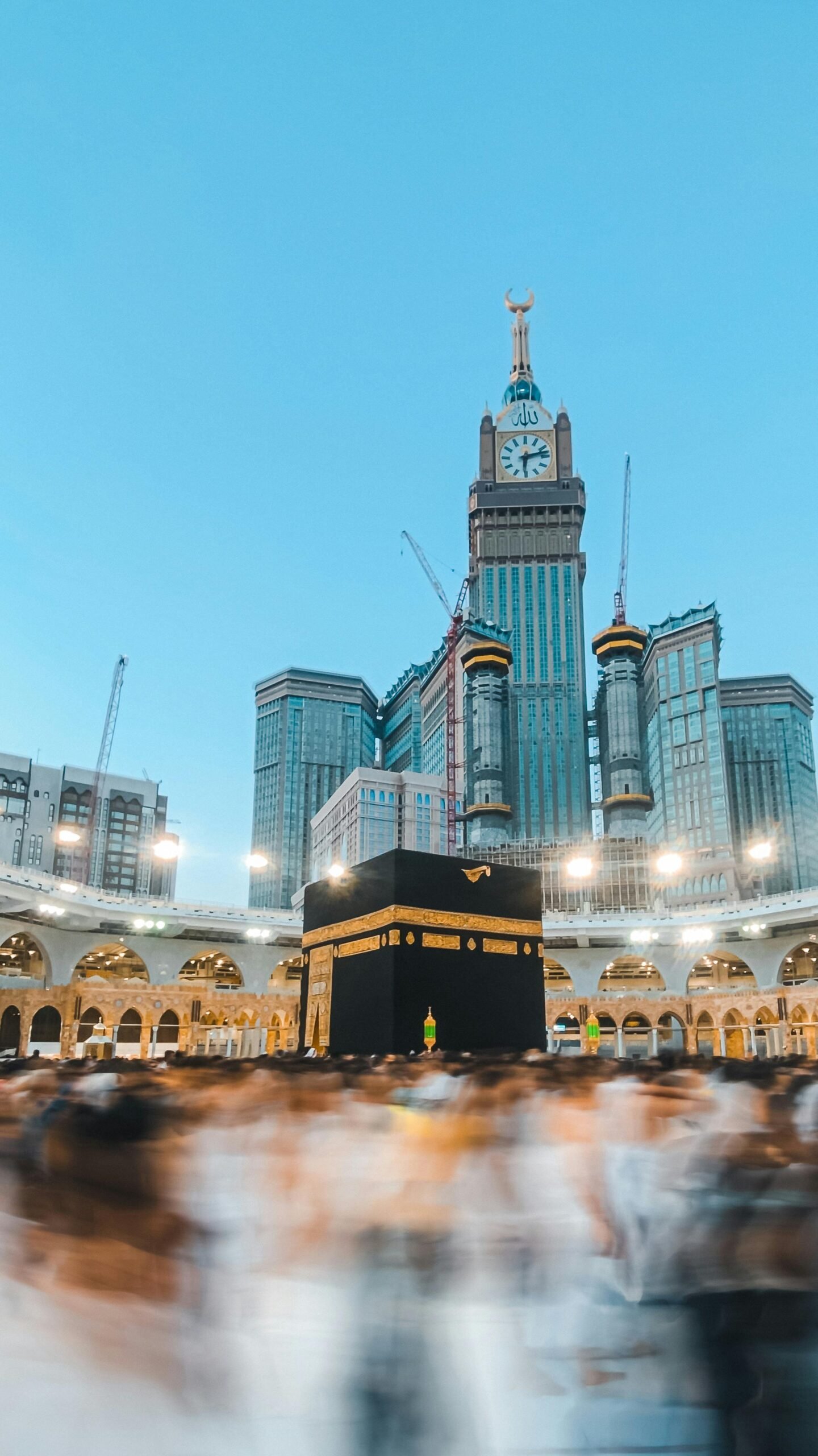 A stunning view of the Kaaba surrounded by blurred worshippers in Mecca's Grand Mosque.